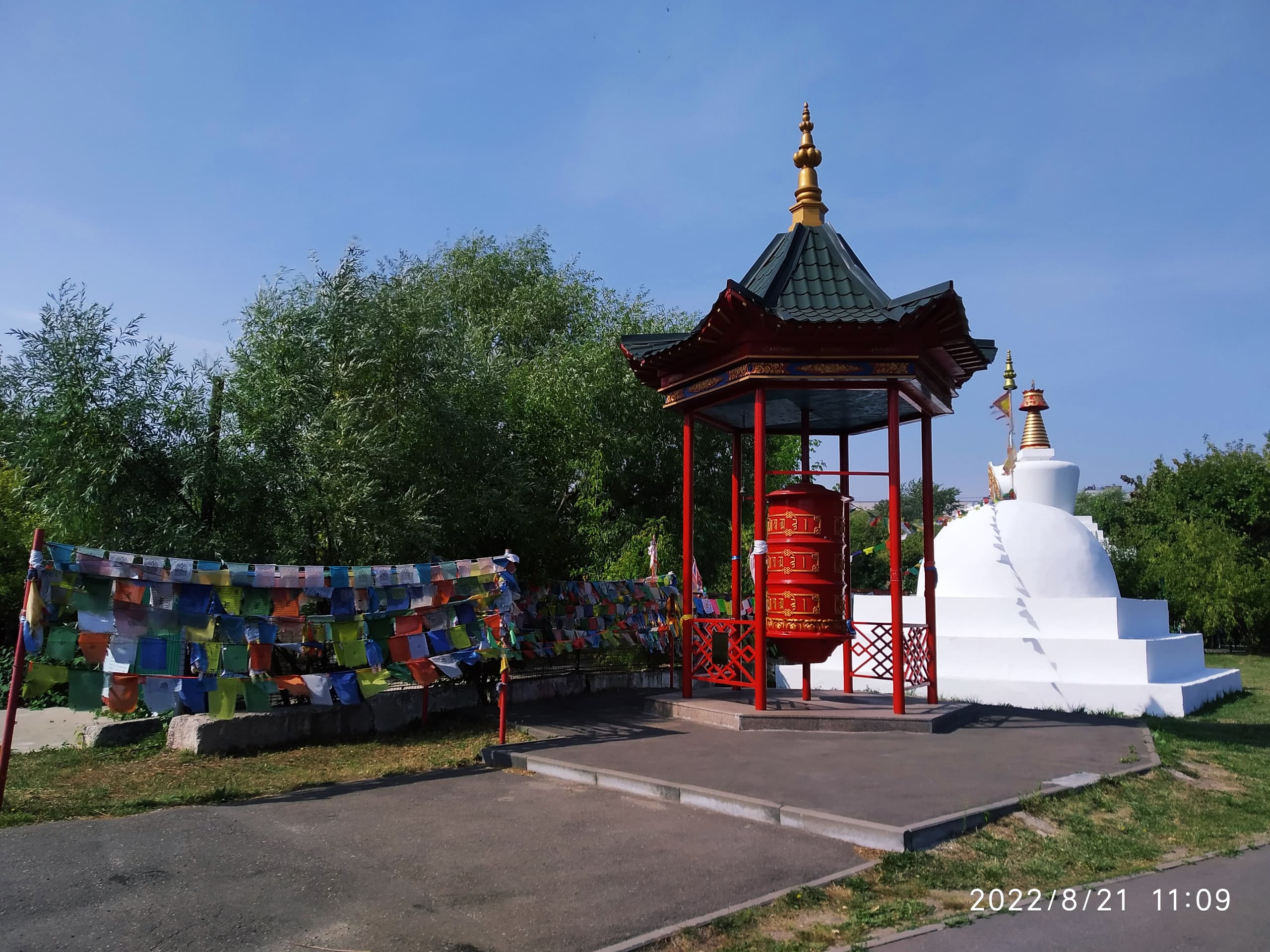 Молитвенный барабан (хурдэ) с тибетскими флажками лунгта у Золотой обители, Элиста